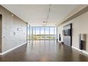 Expansive living room with sleek hardwood floors, floor to ceiling windows, and water views at 1155 N Gulfstream Ave # 1709, Sarasota, FL 34236