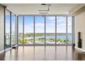 Spacious living room featuring floor to ceiling windows offering a beautiful view of the water and marina at 1155 N Gulfstream Ave # 1709, Sarasota, FL 34236