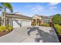 Stunning home featuring a three-car garage and manicured landscaping, and inviting curb appeal at 11603 Gramercy Park Ave, Bradenton, FL 34211