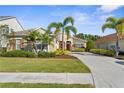 Inviting home featuring a well-maintained lawn, tidy landscaping, and a paved driveway at 11603 Gramercy Park Ave, Bradenton, FL 34211