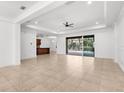 Open concept living room featuring tile flooring, recessed lighting, and sliding glass doors to the pool at 11603 Gramercy Park Ave, Bradenton, FL 34211