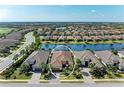 Beautiful aerial view of home, neighborhood, and water in gated community at 13214 Treviso Dr, Bradenton, FL 34211