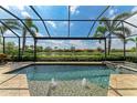 Screened-in pool with lovely lake views, fountains, and spa at 13214 Treviso Dr, Bradenton, FL 34211