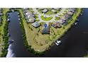 Aerial view of waterfront property in cul-de-sac with private dock and lush landscaping at 14540 Gaspar Loop, Port Charlotte, FL 33981