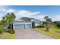 Charming single-Gathering home featuring a three-car garage and well-manicured lawn at 14540 Gaspar Loop, Port Charlotte, FL 33981