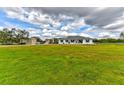 Sprawling green lawn surrounds this single-story home with a large garage providing ample parking at 15890 County Road 675, Parrish, FL 34219