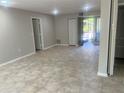 Open living room with tile flooring, neutral paint, and a bright, airy feel at 1697 Brookhouse Cir # 116, Sarasota, FL 34231