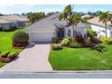 Attractive single-story home featuring a paver driveway, lush landscaping and a well-manicured lawn at 1720 85Th Nw Ct, Bradenton, FL 34209