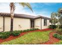 Attractive home featuring well-maintained landscaping, green grass, and accent plants at 19962 Benissimo Dr, Venice, FL 34293