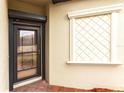 Front entryway with a secure front door and a decorative diamond-patterned window at 19962 Benissimo Dr, Venice, FL 34293