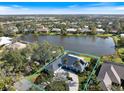 Beautiful lakefront property, including a screened-in pool and circular drive at 28 Dominica Dr, Englewood, FL 34223