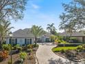 Inviting home featuring a well-manicured front yard and a circular driveway at 28 Dominica Dr, Englewood, FL 34223