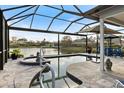 Relaxing screened-in pool with a spa and waterfront views at 28 Dominica Dr, Englewood, FL 34223