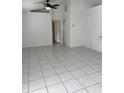 Bright living room with tile flooring and a ceiling fan at 3722 S Cranberry Blvd, North Port, FL 34286