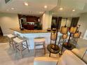 The bar area features modern stools, mirrored wall, and adjoins the eat-in kitchen at 500 N Osceola Ave # 203, Clearwater, FL 33755