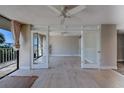 Open-concept living area with access to a spacious balcony overlooking serene waters and natural beauty at 500 N Osceola Ave # 203, Clearwater, FL 33755