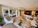Bright living area includes a comfortable seating area, bar seating, and views into the bedroom at 500 N Osceola Ave # 203, Clearwater, FL 33755