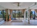 Bright living room with floor-to-ceiling windows leading to a private balcony with scenic views at 500 N Osceola Ave # 203, Clearwater, FL 33755