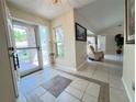 Inviting foyer with tile flooring, neutral paint, and a view into the spacious living area at 5714 Garden Lakes Fern, Bradenton, FL 34203