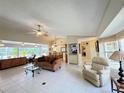 Bright open-concept living room featuring tile floors, ceiling fans, and natural light at 5714 Garden Lakes Fern, Bradenton, FL 34203