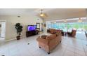 Spacious living room with tile flooring, vaulted ceiling, and comfortable seating arrangements at 5714 Garden Lakes Fern, Bradenton, FL 34203