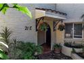 Inviting front entrance featuring hanging flower baskets and well-maintained landscaping at 6101 34Th W St # 21E, Bradenton, FL 34210