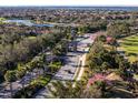 Aerial view of a community featuring lush landscaping, serene lakes, and meticulously maintained streets at 6560 Willowshire Way, Bradenton, FL 34212