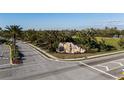 Community entrance to River Strand featuring a decorative rock waterfall and lush greenery at 6560 Willowshire Way, Bradenton, FL 34212