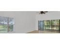 Bright living room featuring neutral tile, large windows, and a sliding glass door to the lanai at 6639 Pineview Ter # 6639, Bradenton, FL 34203