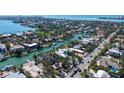 An aerial view features a stunning waterfront home, lush landscaping, and serene neighborhood at 732 Siesta Dr, Sarasota, FL 34242