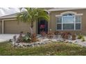 Close up of front yard landscaping, rocks, plants and grass at 7951 113Th Avenue E Cir, Parrish, FL 34219