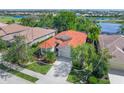 Beautiful single-Gathering home with a well-maintained lawn, landscaping, and a tile roof at 8956 Stone Harbour Loop, Bradenton, FL 34212