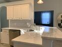 Bright kitchen features modern countertops, stainless steel sink, and white cabinetry at 8956 Stone Harbour Loop, Bradenton, FL 34212