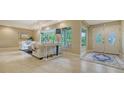 Inviting living room with neutral tones, large windows, and views of the lush outdoor greenery at 940 Siesta Key Pl, Sarasota, FL 34242