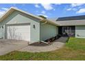 This home boasts an attached two-car garage, screened-in porch, and manicured landscaping for a welcoming curb appeal at 1239 Pinebrook Way, Venice, FL 34285