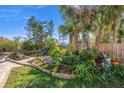 Tropical backyard oasis with pond, waterfall, and lush landscaping at 1565 Saturn Rd, Venice, FL 34293