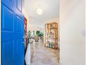 Bright foyer featuring tile flooring and decor, leading into a spacious living area at 1718 Starling Dr # 104, Sarasota, FL 34231