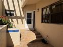 Welcoming front entrance with tiled steps, pergola, and decorative accents at 1718 Starling Dr # 104, Sarasota, FL 34231