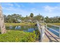 Scenic view of a pond crossed by a charming wooden bridge, surrounded by mature trees and landscaping at 2320 Terra Ceia Bay Blvd # 406, Palmetto, FL 34221