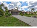 A well maintained home with a long drive and lush landscaping at 2625 Yuma Ave, North Port, FL 34286