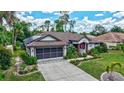 Lovely one-story home with a well-kept lawn, screened garage, solar panel and beautiful landscaping at 2625 Yuma Ave, North Port, FL 34286