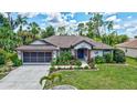 Beautiful single-story house with a well-manicured lawn and a screened garage at 2625 Yuma Ave, North Port, FL 34286