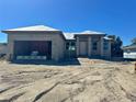 New construction exterior featuring block construction and an attached two-car garage at 3299 Pinetree St, Port Charlotte, FL 33952