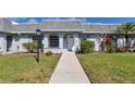Inviting villa featuring a well-maintained lawn and walkway leading to the front door at 4104 35Th W Ave, Bradenton, FL 34205
