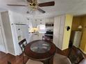 Cozy eat-in kitchen with white cabinets, stainless steel appliances, and a round dining table at 415 Dublin Ave, Bradenton, FL 34207