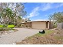 Home exterior showing the driveway and damage from the hurricane at 5073 Higel Ave, Sarasota, FL 34242