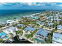 Lovely coastal home with pool and dock, surrounded by beautiful landscaping and waterfront access at 526 Loquat Dr, Anna Maria, FL 34216