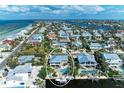 Lovely coastal home with pool and dock, surrounded by beautiful landscaping and waterfront access at 526 Loquat Dr, Anna Maria, FL 34216