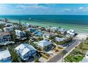 Beautiful coastal homes near the ocean, surrounded by lush landscaping and clear blue water at 526 Loquat Dr, Anna Maria, FL 34216
