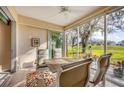 Enclosed lanai featuring a dining table and chairs with a ceiling fan overlooking a beautiful tree at 6314 Stone River Rd # 6314, Bradenton, FL 34203